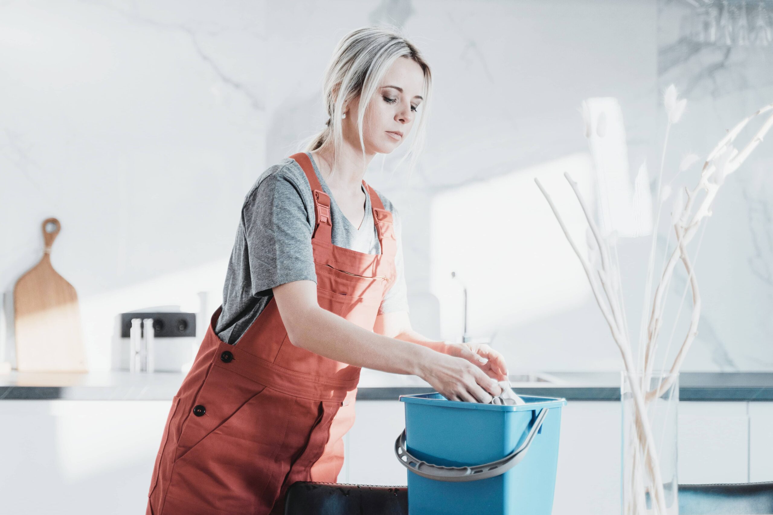 professional cleaner in kitchen of real estate listing